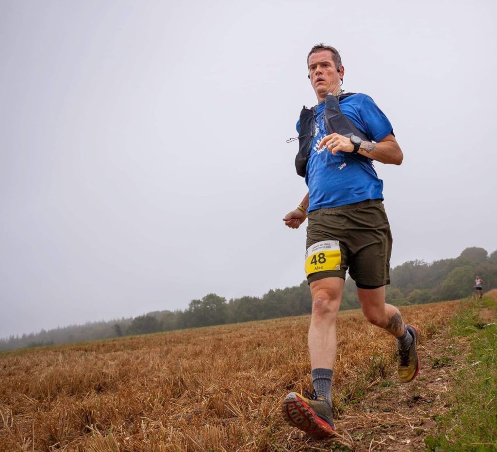 Alex running down a hill during the Andover Trail Marathon in preparation for an upcoming ultramarathon.