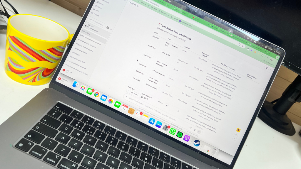 Laptop showing AI training plan next to a yellow cup of coffee